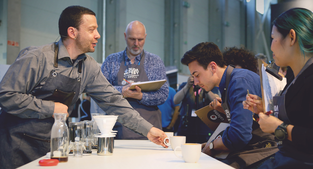 Hometown competitor Marton Lonkai of Steamhouse serving coffee to the judges.